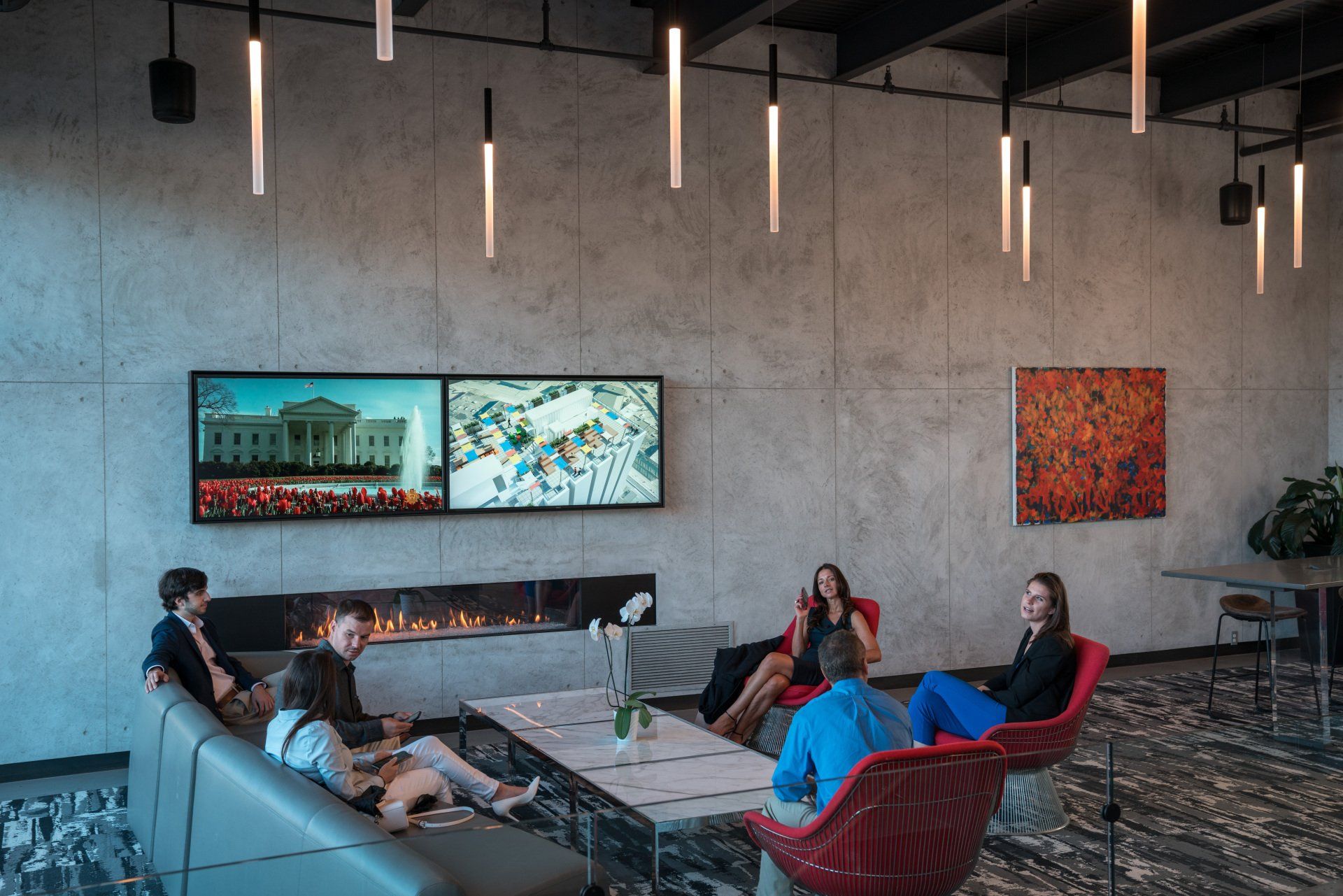 A group of people are sitting around a table in a living room.