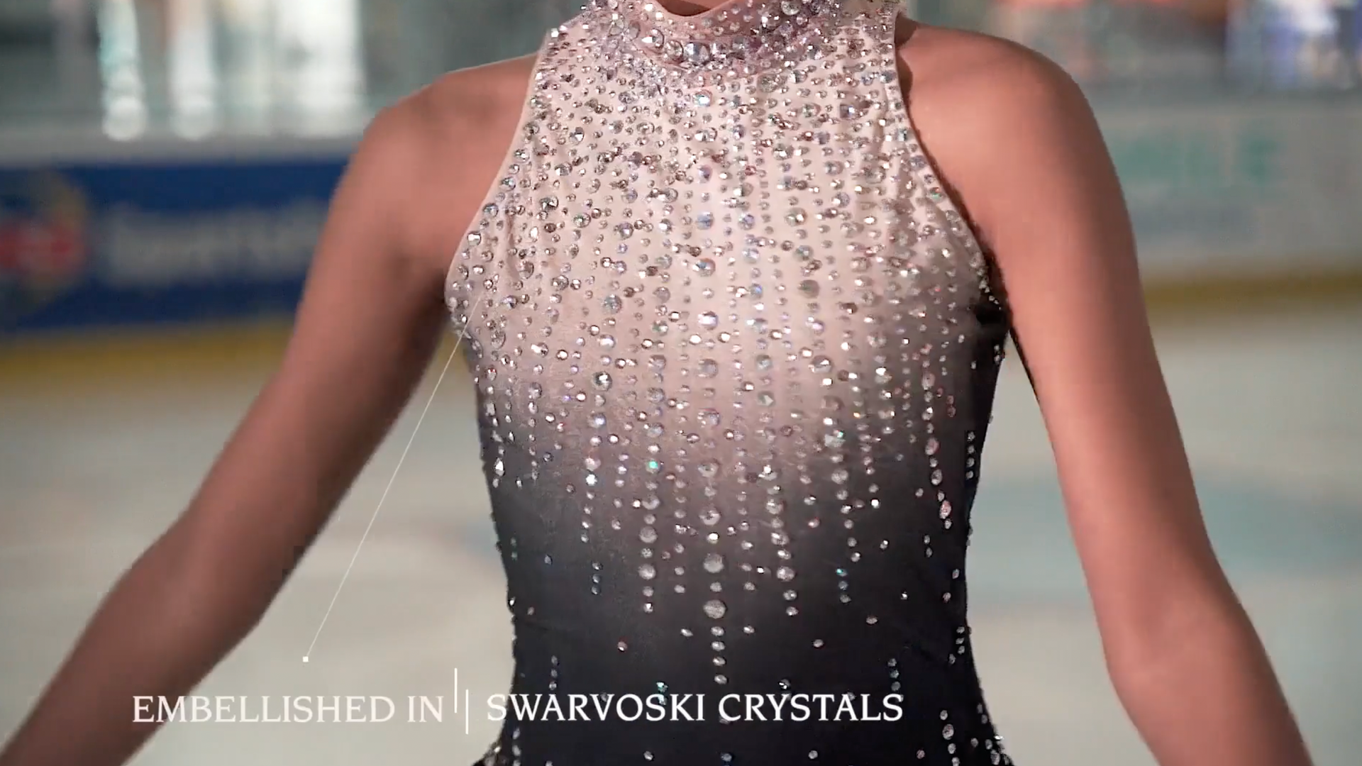 A woman in a black dress with swarovski crystals on it