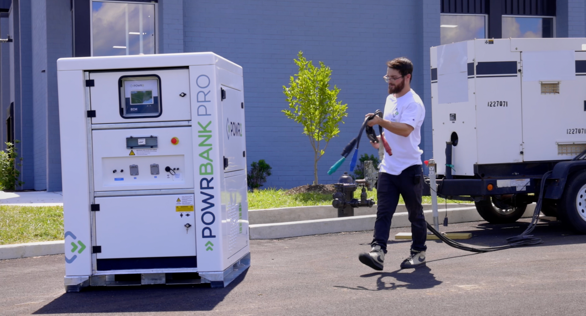 A man is standing next to a white box that says powerbank pro.