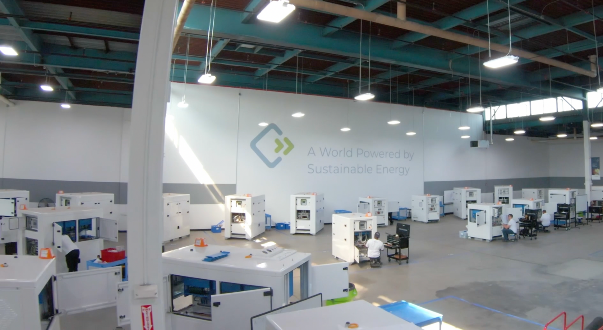 A large warehouse filled with lots of machinery and a sign that says a connected world