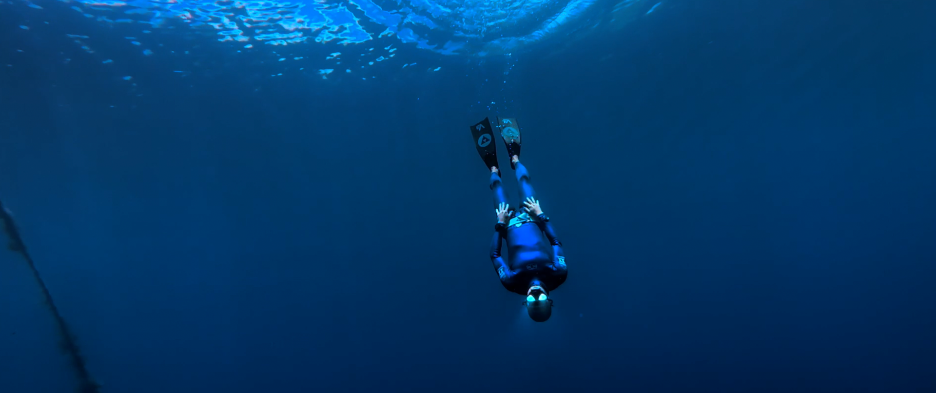A person is swimming underwater in the ocean.