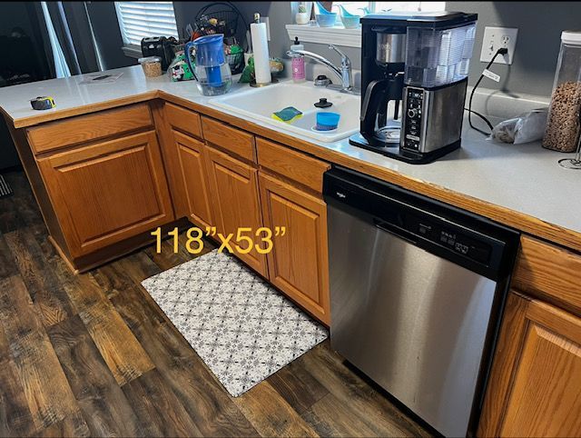 Kitchen corner with wooden cabinets, sink, coffee maker, dishwasher, and a marked 118