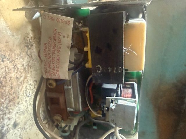 Open electronic device with exposed circuit board, wires, and components inside a beige casing