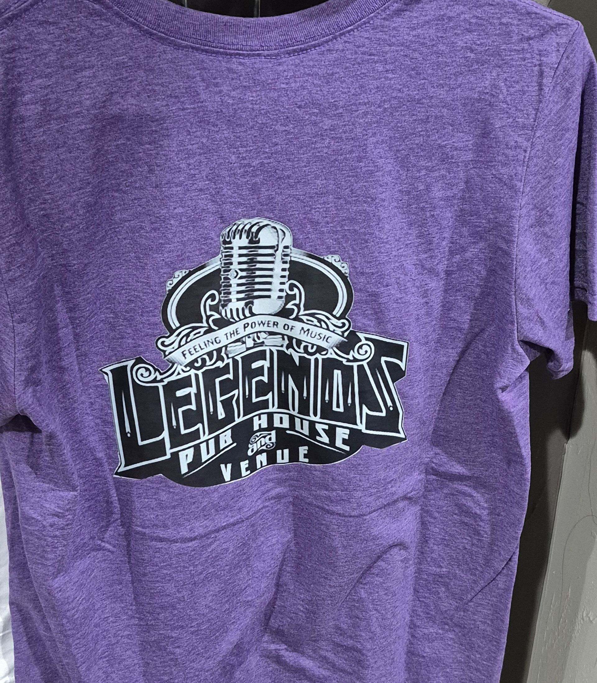 Purple T-shirt with a black-and-white microphone graphic and the word “LEGENDS” on the chest.