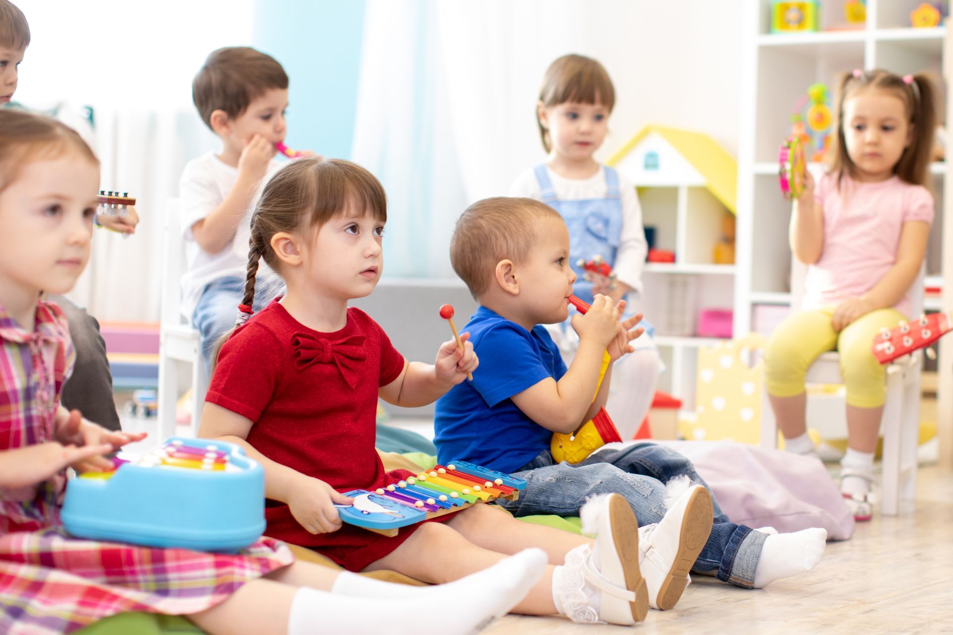 Music lesson for a group of children in kindergarten or a kids’ centre. Music lesson for a group of children in kindergarten or a kids’ centre.