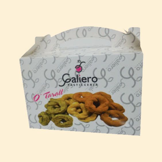 Galiero Tarsali confezionava pasticcini a forma di anello in una scatola bianca con spirali grigie e snack colorati sul davanti.