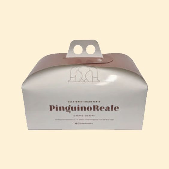 Scatola per dessert grigia con etichetta “PingüinoReale”, coperchio marrone e due manici bianchi.
