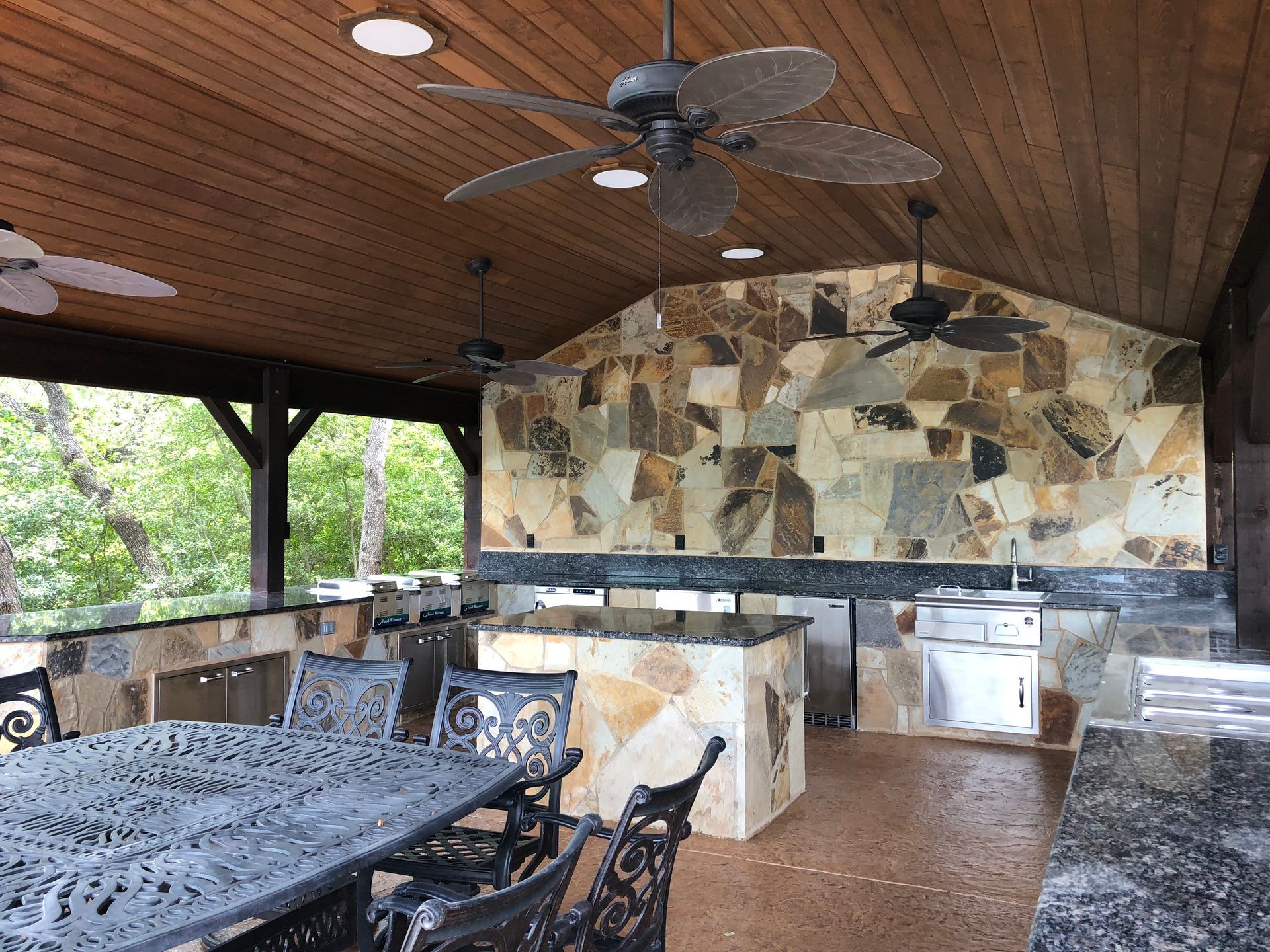 Custom outdoor kitchen design in San Antonio with integrated dining area
