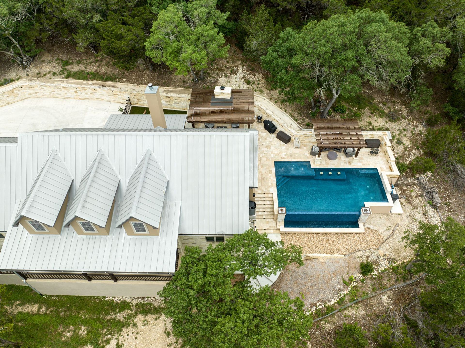 An aerial view of a house with a swimming pool built by Fine Patio Design San Antonio TX