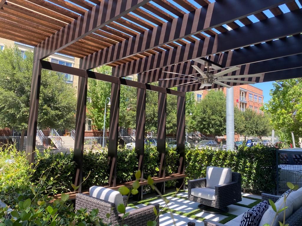 A patio with a pergola and a ceiling fan built by Fine Patio Design San Antonio TX