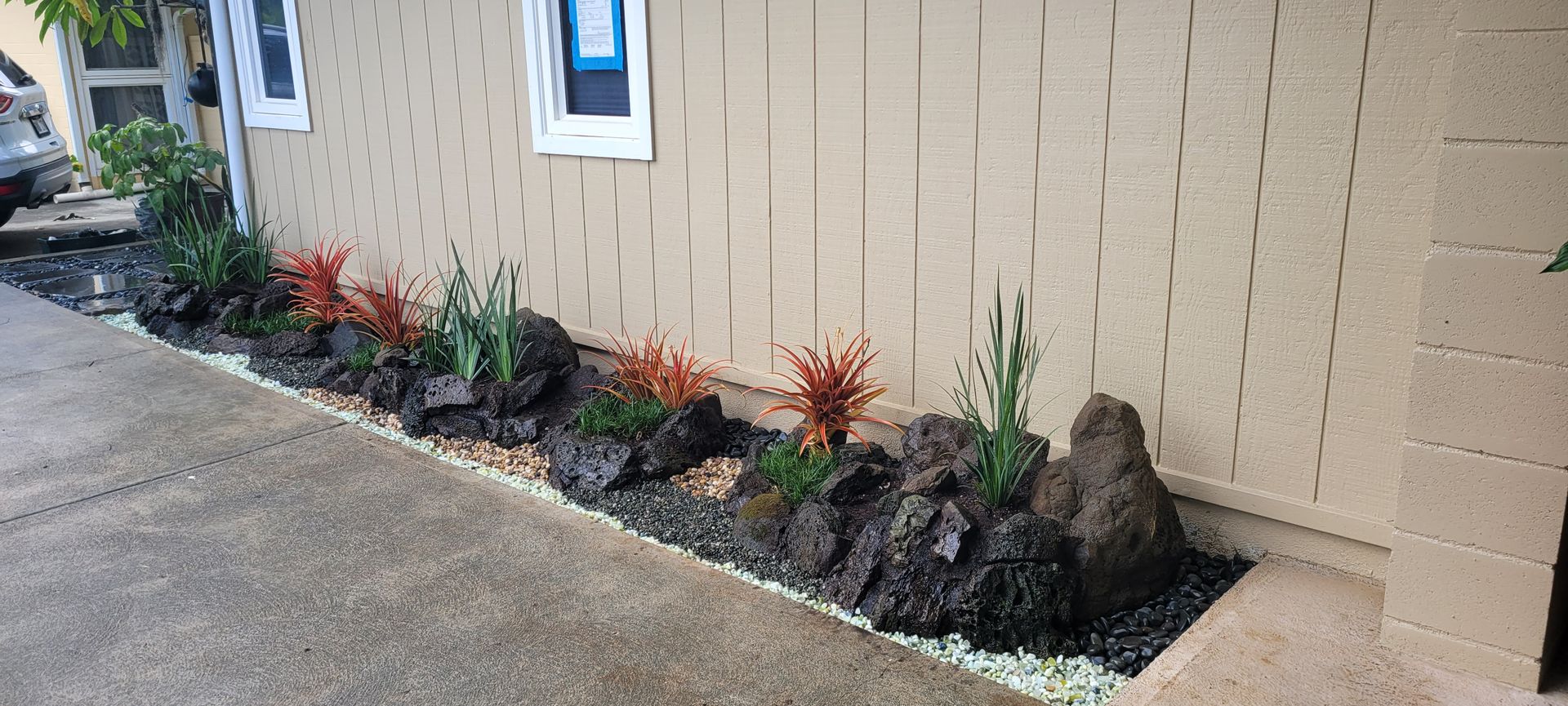rocks and plants installed along house