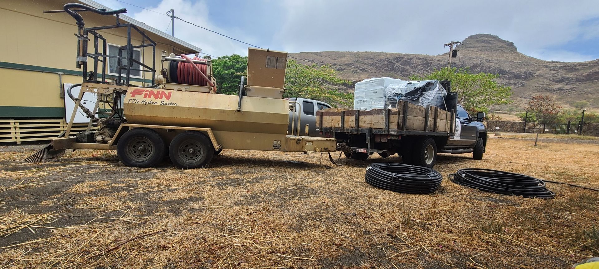 truck with hydroseeding machinery parked in front lawn