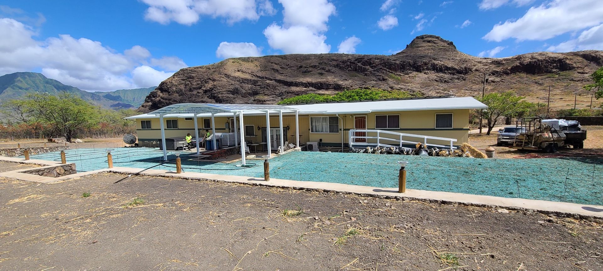 house with patio surrounded by fresh hydroseeded lawn