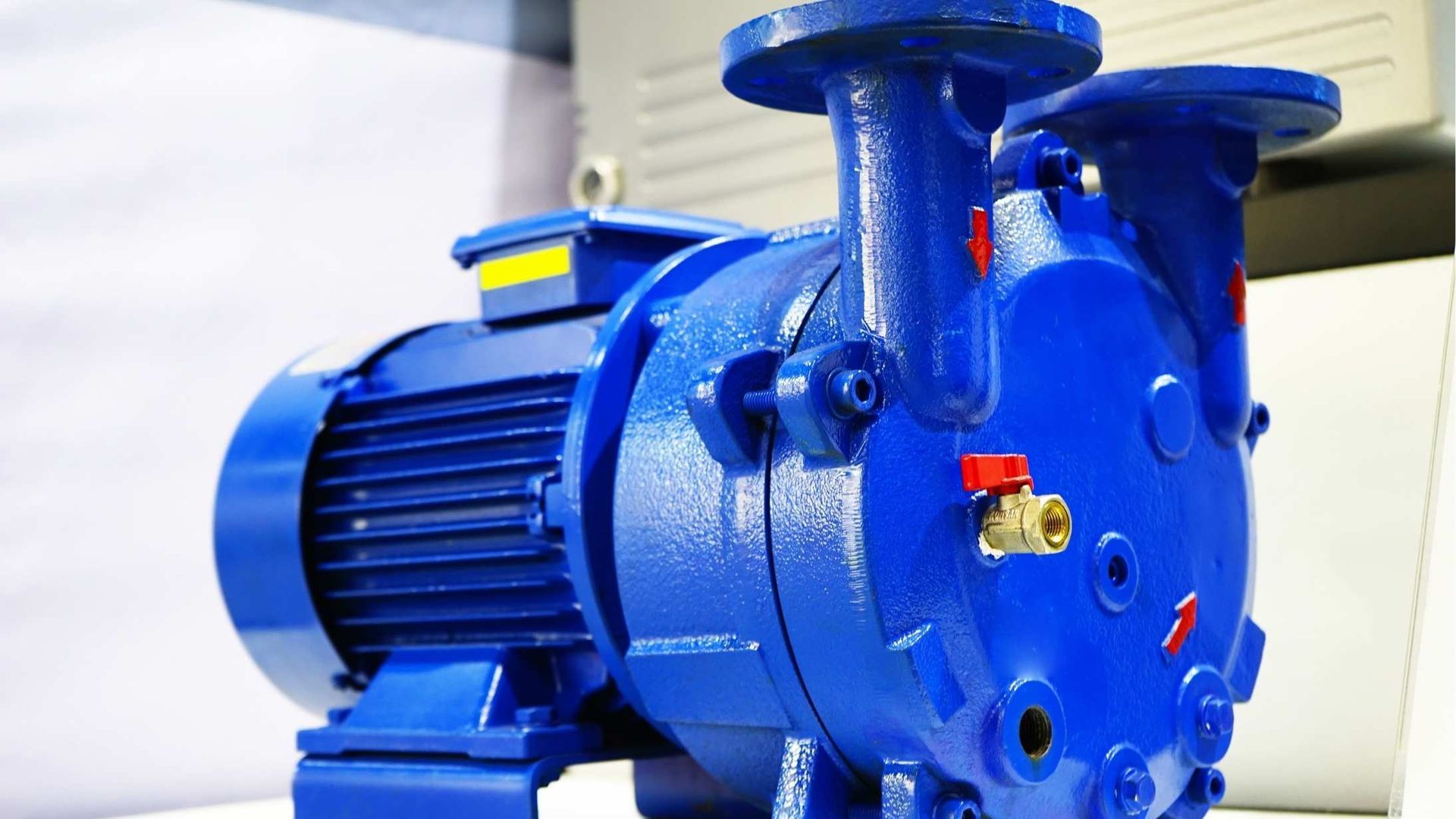 A blue water pump is sitting on a white table.
