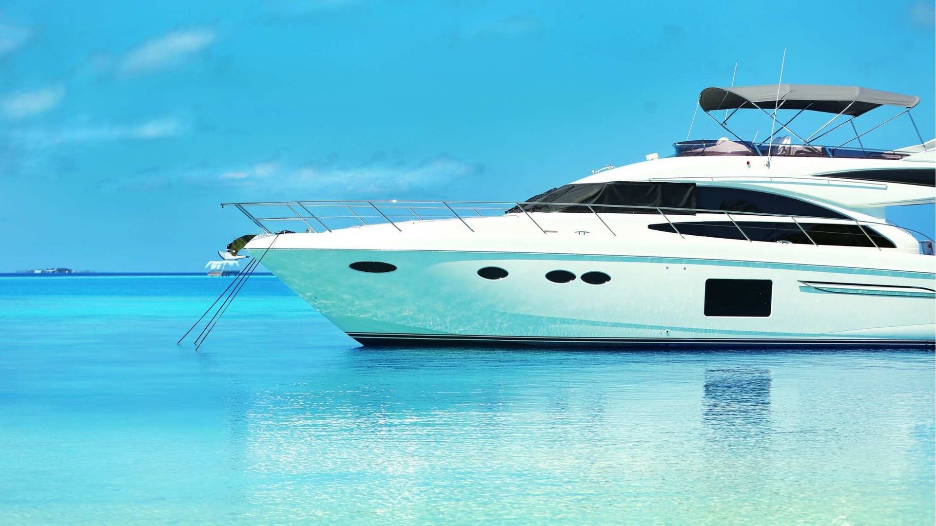 A white yacht is docked in the middle of the ocean.