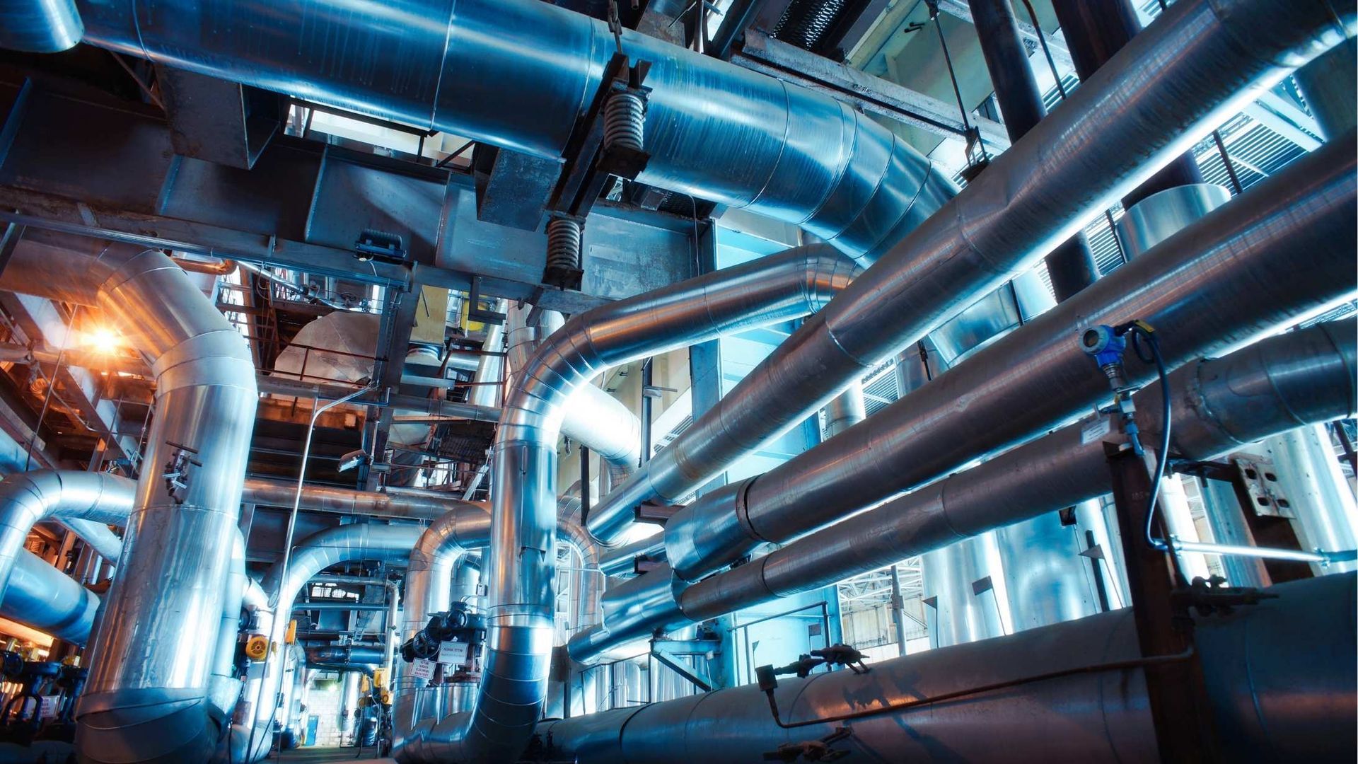 A factory filled with lots of pipes and lights.