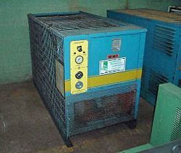 A blue and yellow machine is sitting in a room.