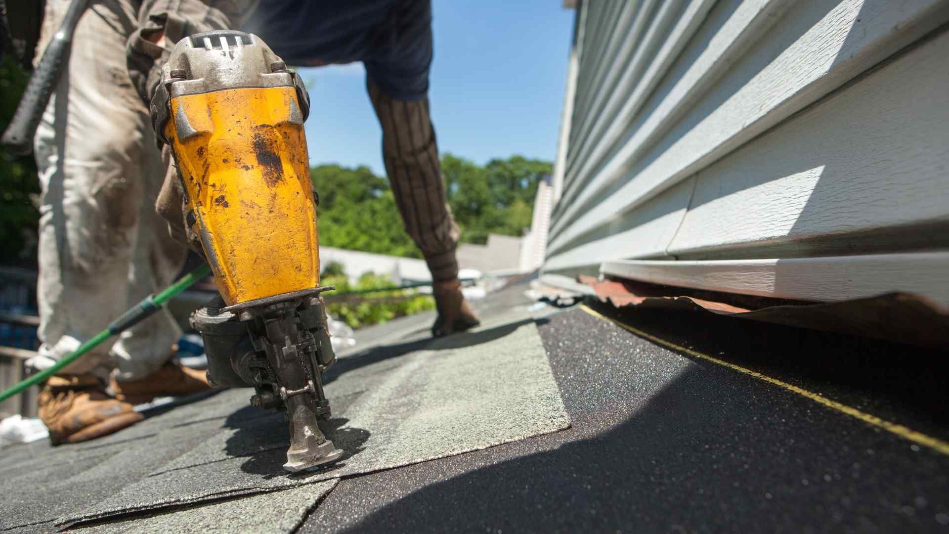 TrustWorks Construction_Picture of a a roofer fixing the damaged roof.