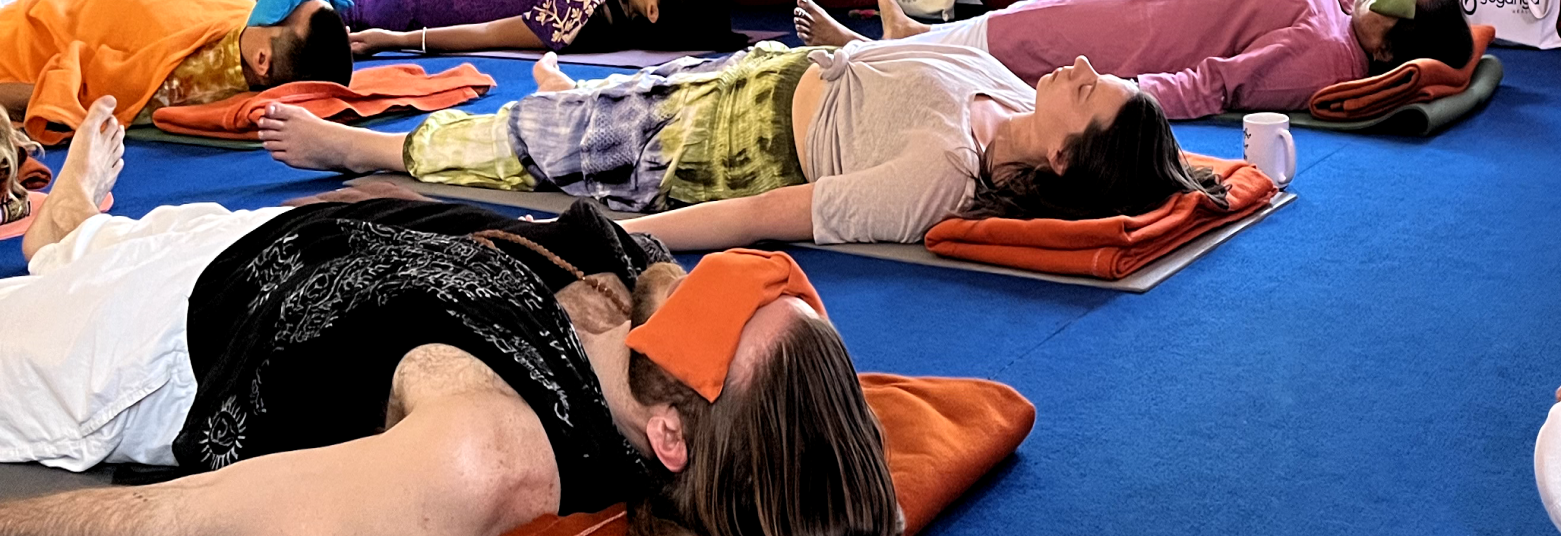 Practice of guided meditation of Yoga Nidra for deep relaxation at Yoganga Healing Rishikesh