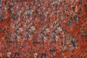 Close-up of red and black speckled stone or granite surface.