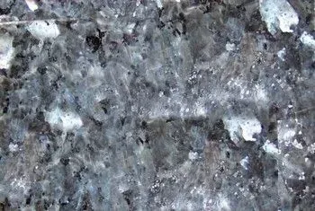 Close-up of a gray speckled stone or granite surface with white flecks