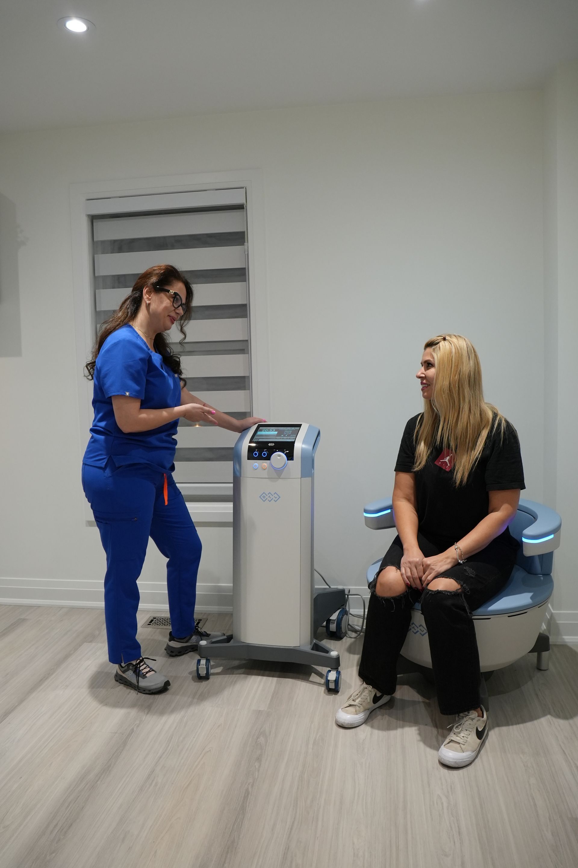 Pelvic floor therapy consultation at N.H.F Clinics in Newmarket, using a HIFEM treatment chair