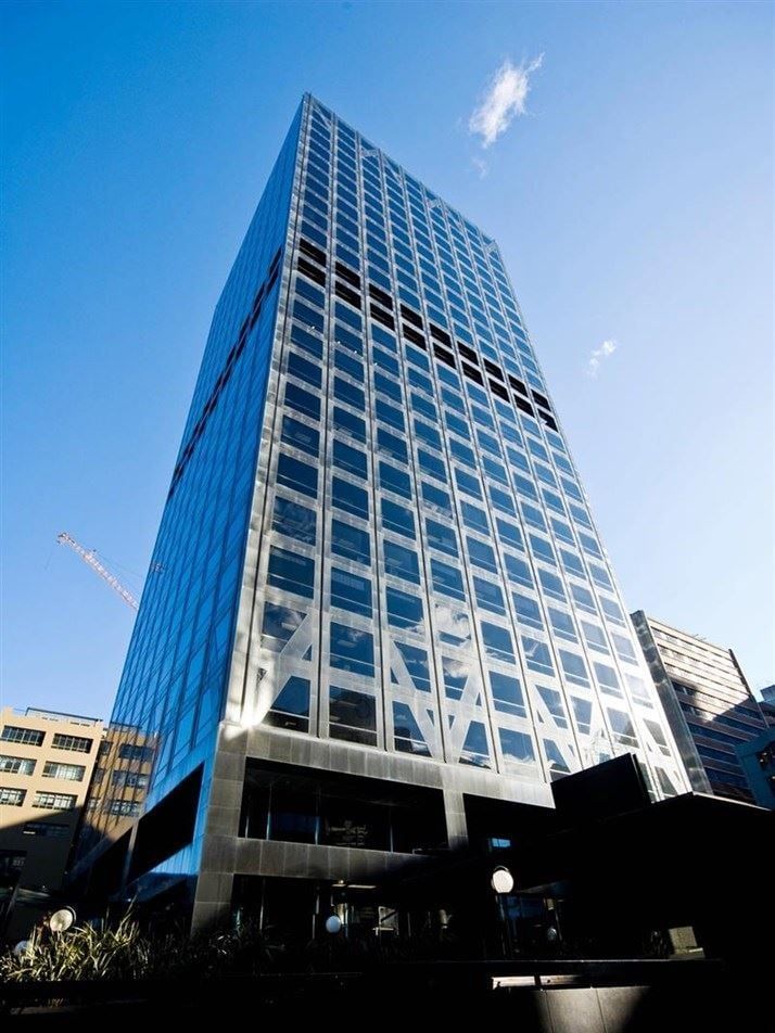 Looking up at a tall building with a blue sky in the background