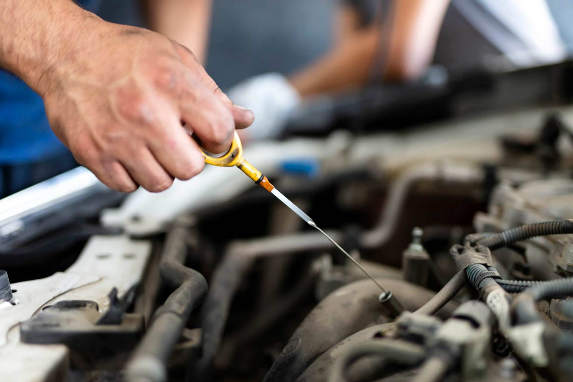 Mechanic inserting oil into car — Gary, IN — Macer Transportation Mechanic inserting oil into car — Gary, IN — Macer Transportation