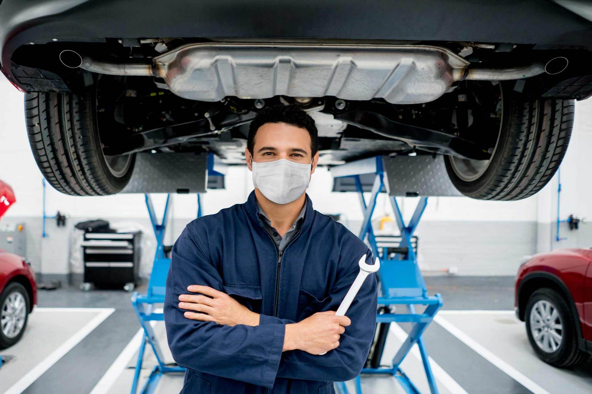 Mechanic holding wrench below car — Gary, IN — Macer Transportation Mechanic holding wrench below car — Gary, IN — Macer Transportation
