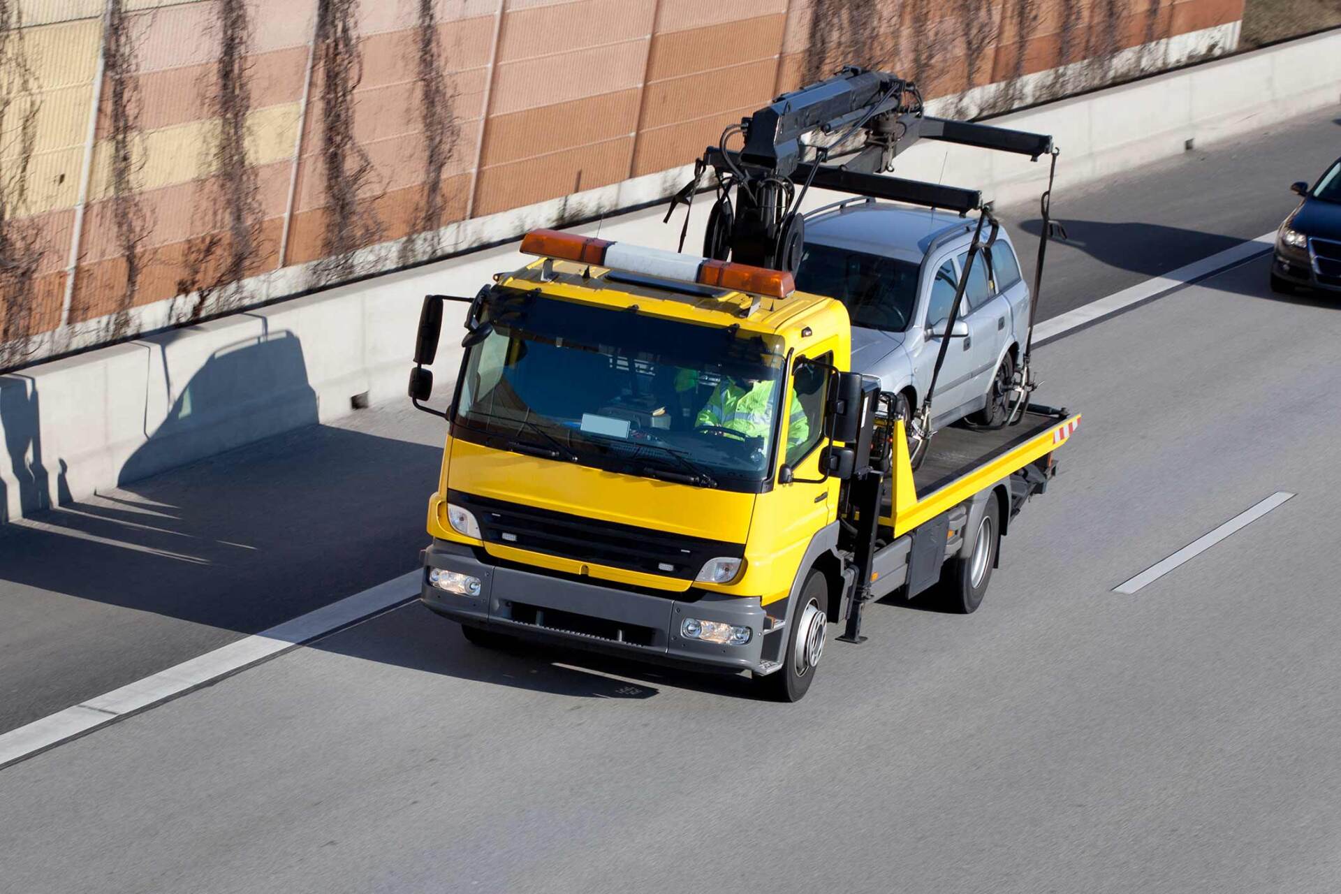 Tow truck with car on highway — Gary, IN — Macer Transportation Tow truck with car on highway — Gary, IN — Macer Transportation