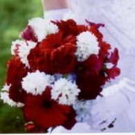 Red and white flower bouquet on a white cloth background