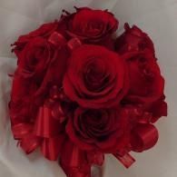 Red rose bouquet with ribbon on a light background