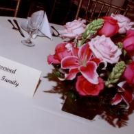 Wedding table with pink floral centerpiece and a “Sealed with love” card