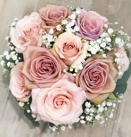 Bouquet of pale pink and lavender roses with baby’s breath