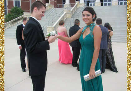 Couple in formalwear holding hands on a staircase at an outdoor event