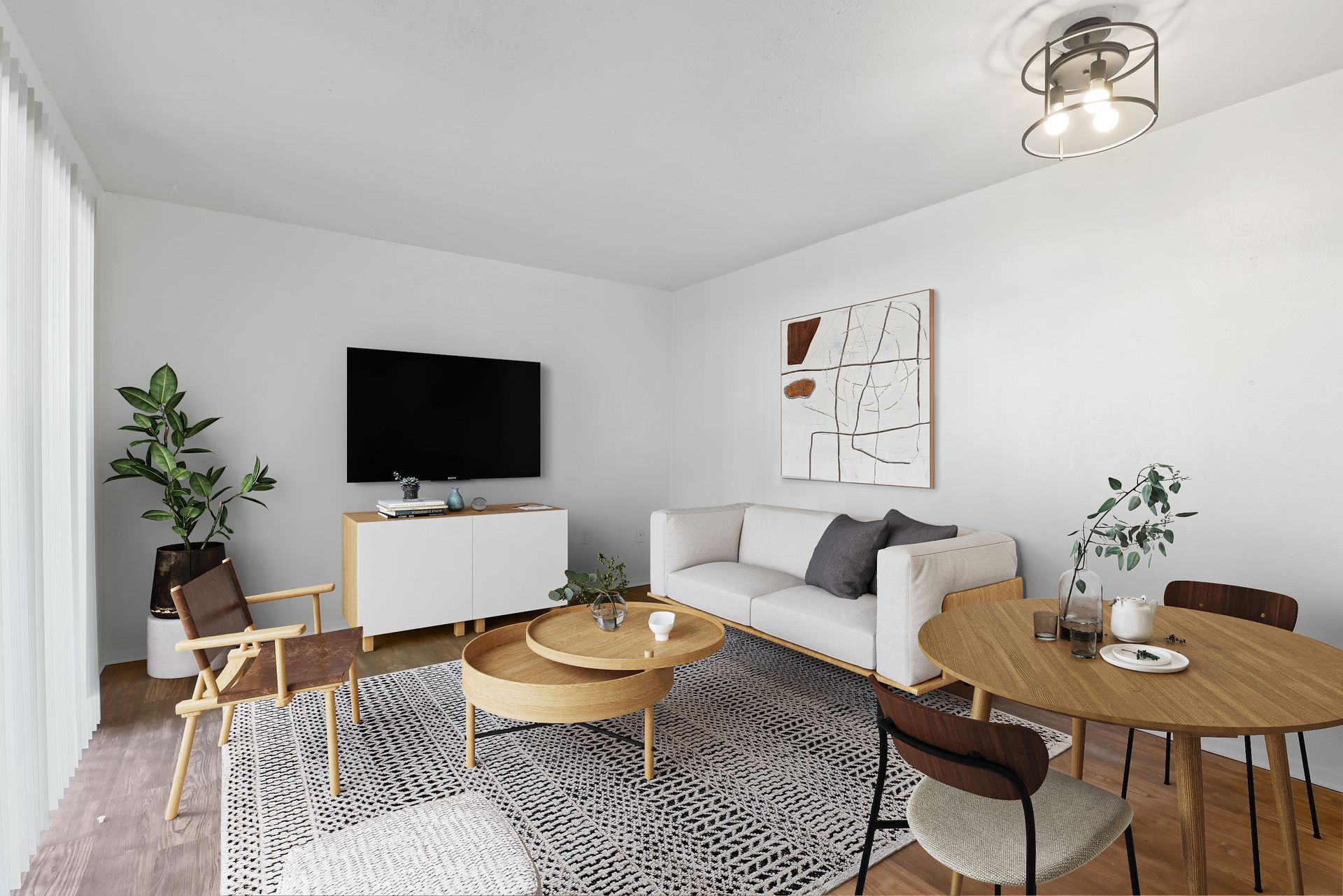 Living room with white walls, modern furniture, and large TV.