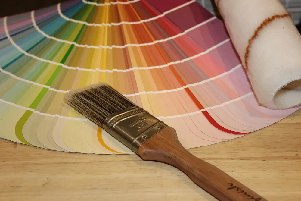 Paint color swatches with a brush on a wooden table