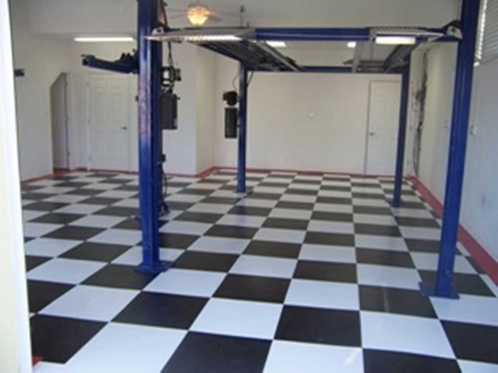 Empty room with black-and-white checkered floor and blue steel lift frame