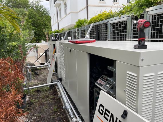 A drill is sitting on top of a generator.