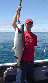 Man in A Red Shirt Is Holding a Large Fish