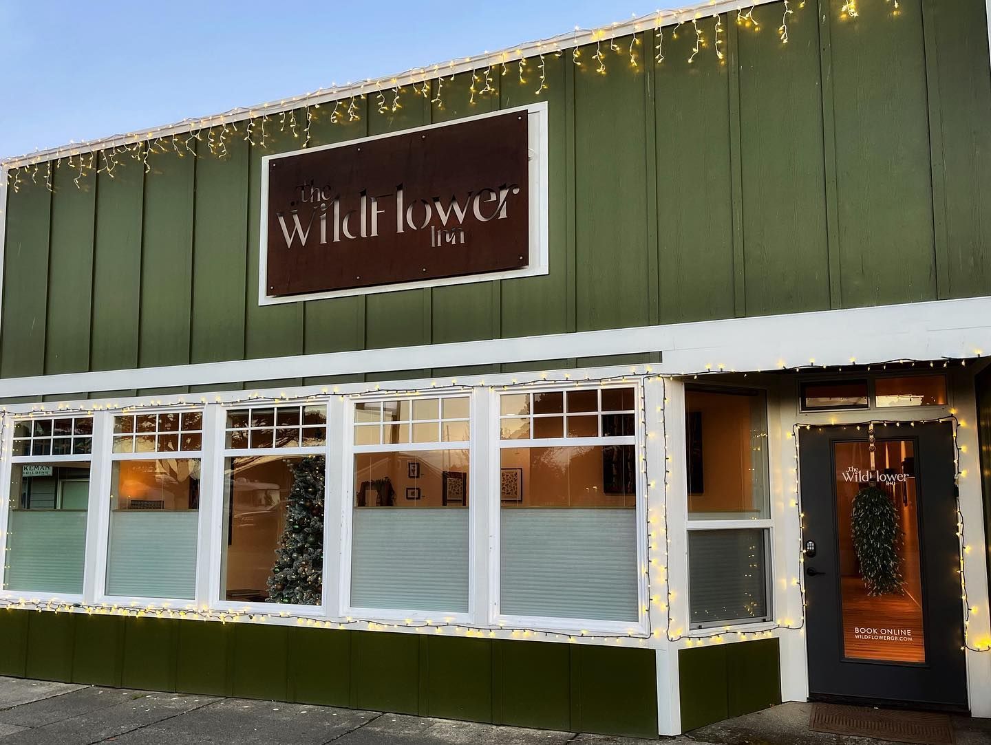 Green Building with A Sign that Says Wildflower on It
