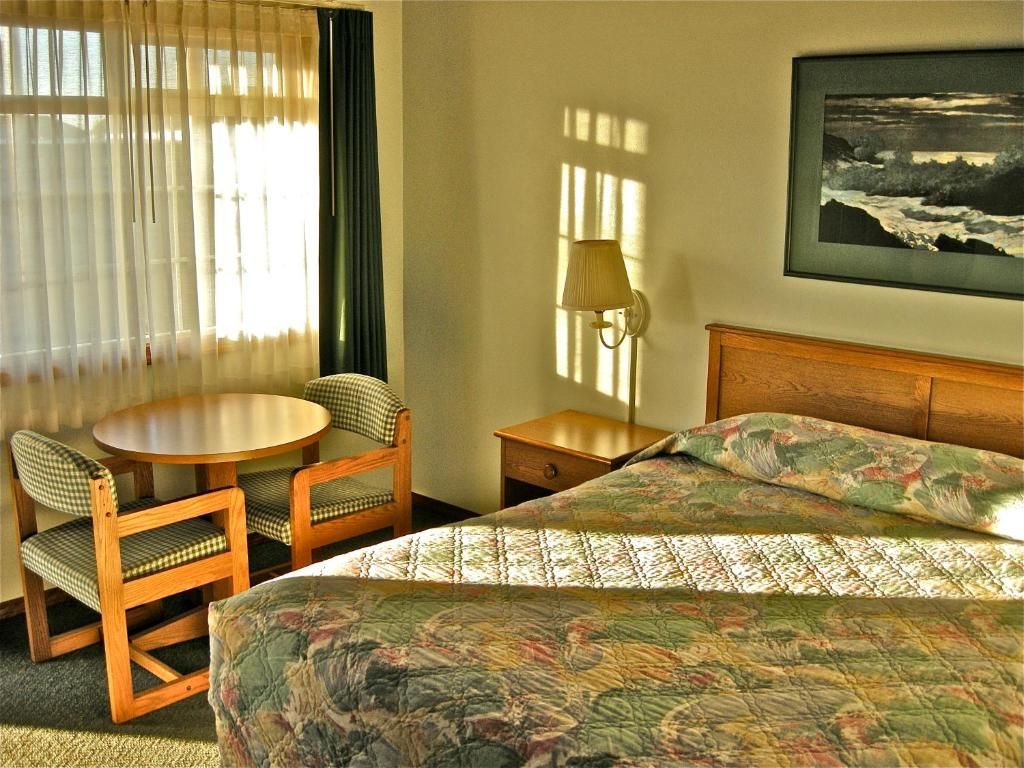 Hotel Room with Two Beds a Table and Chairs