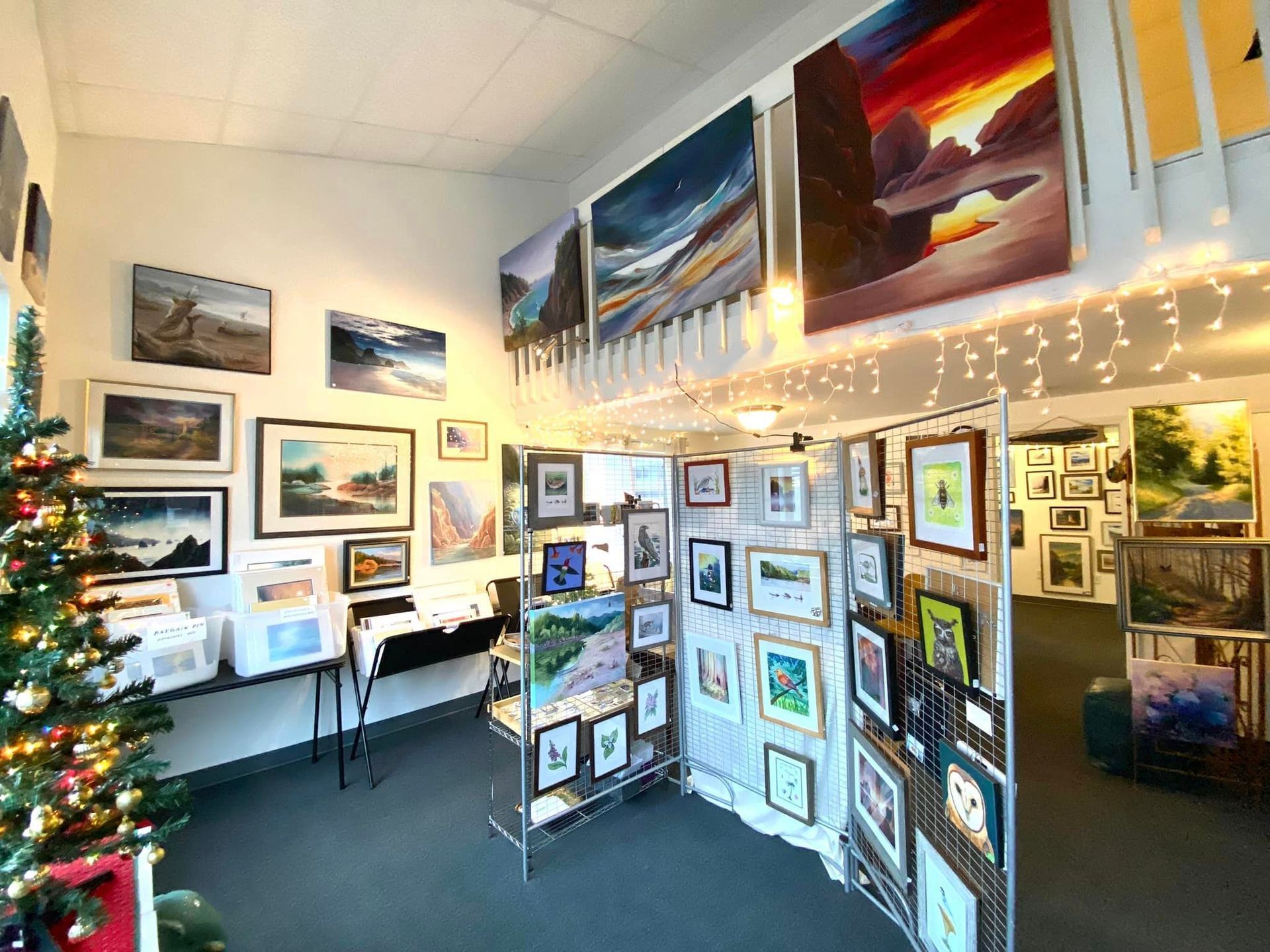 A Room Filled with Lots of Paintings and A Christmas Tree