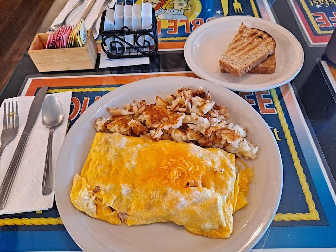 A Plate of Food on A Table that Says ' Omelet ' on It