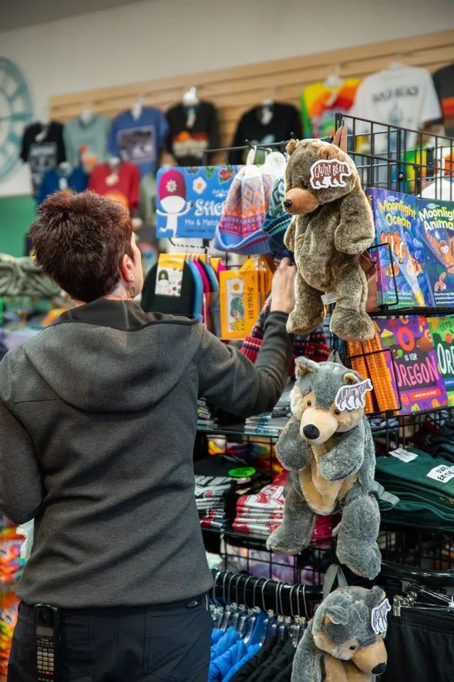 A Woman Is Looking at Stuffed Animals in A Store