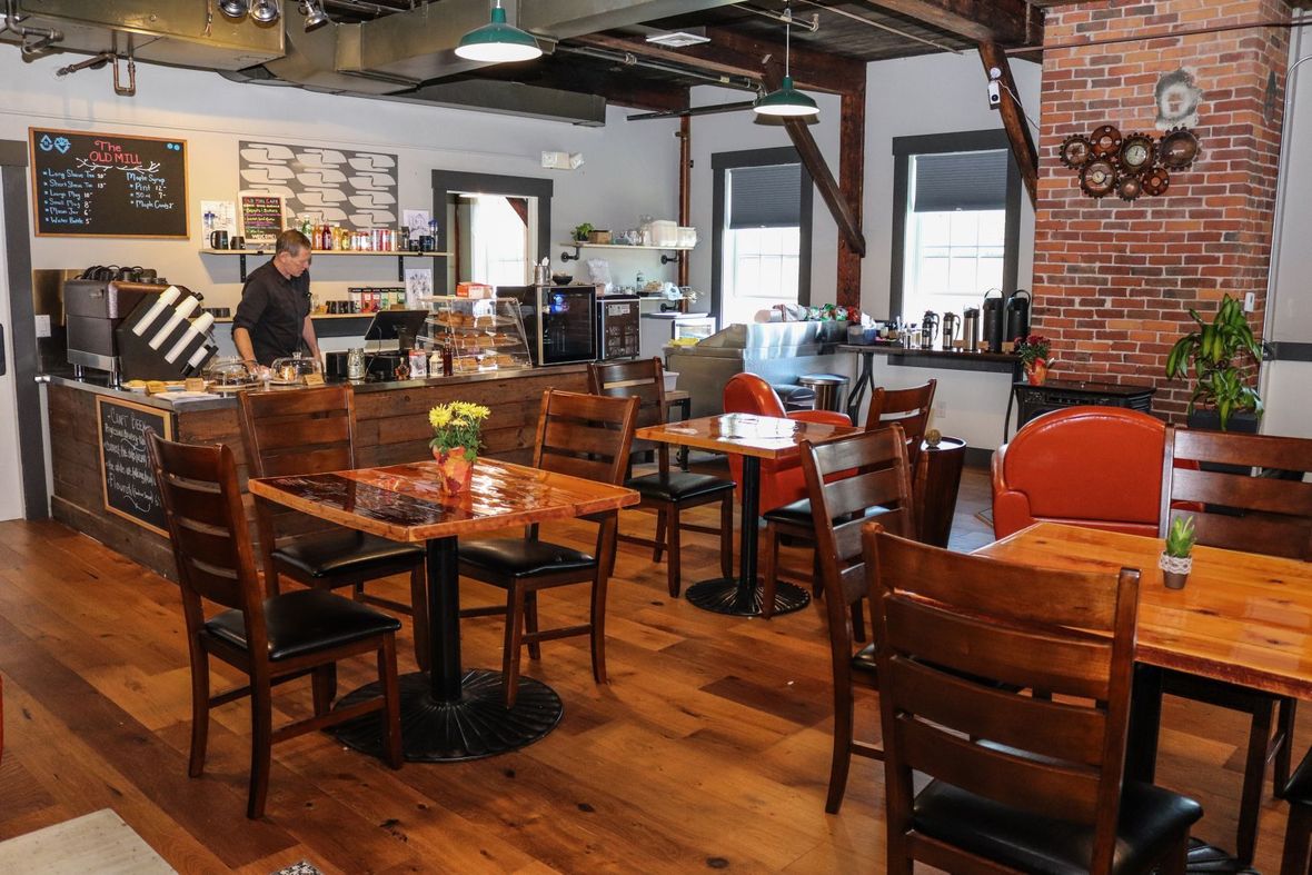 There are many tables and chairs in the restaurant.