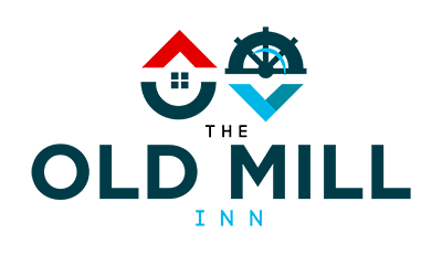 A logo for the old mill inn with a house and a ship wheel