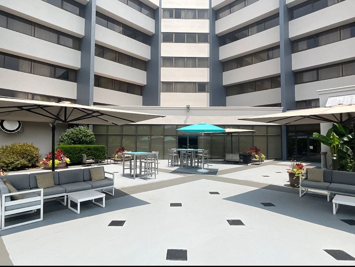 Courtyard with seating, tables, and umbrellas