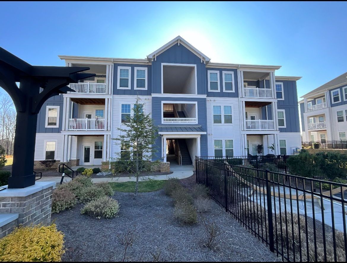 Multi-story apartment building with blue and white siding