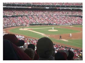 baseball game A crowd of people are watching a baseball game in a stadium.